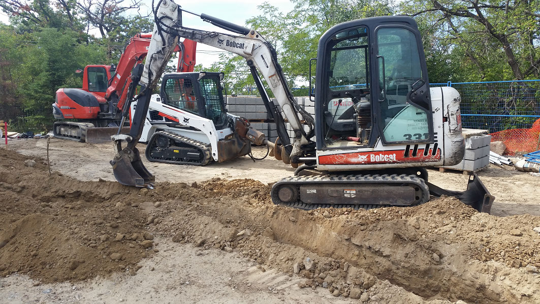 Henry's Bobcat Services 3 excavators in a jobsite